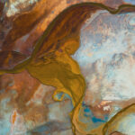 A colorful overhead image of swirling sediment