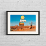 The framed photo "Canyonlands Motel" framed and matted against a white brick wall